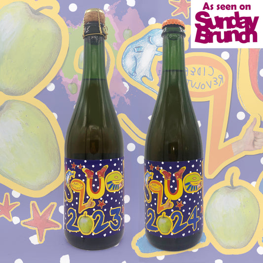 Two green bottles with colorful labels on a decorative background with apples and text.