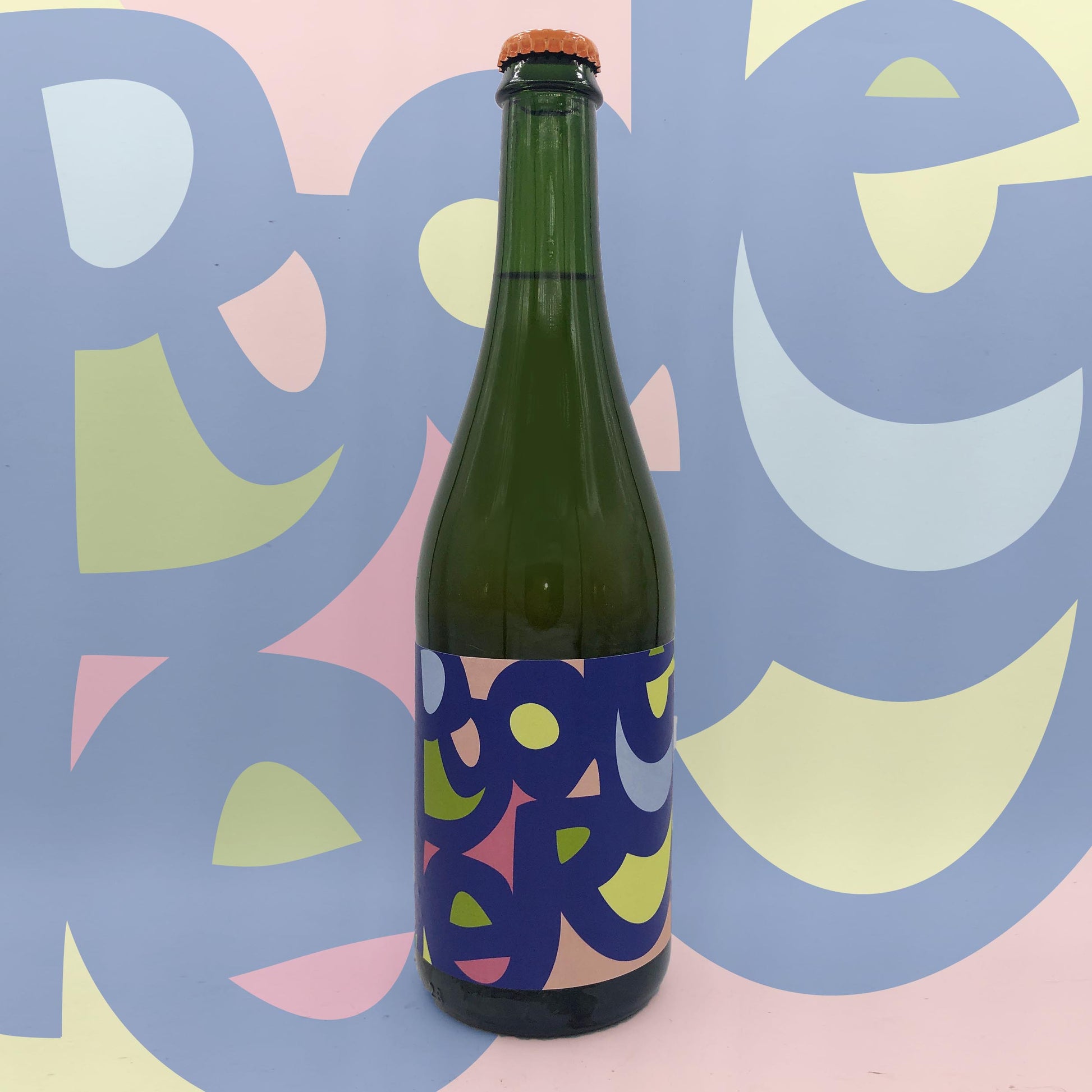 Green bottle with colorful label against a multicolored abstract background